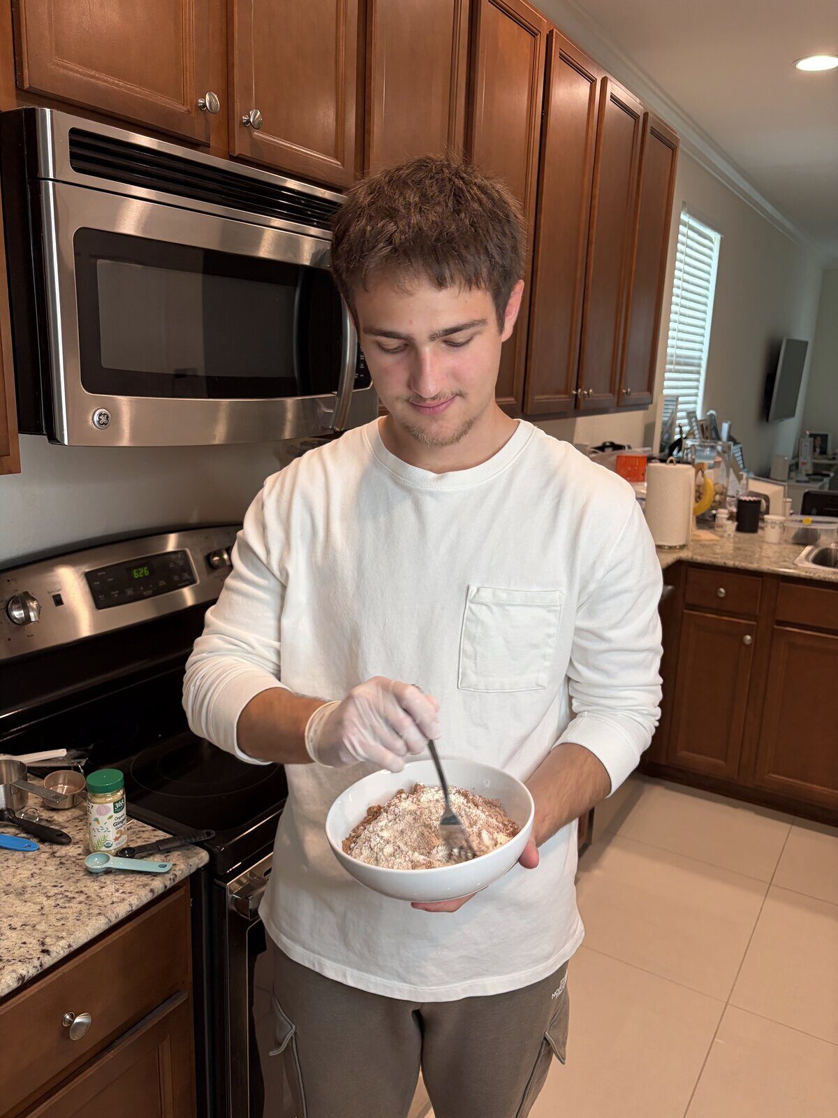Mixing LifeMaxx brownie batter by hand in the cottage kitchen